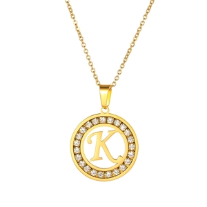 Detail of a gold-plated round K-letter pendant necklace with sparkling micro-pave crystals