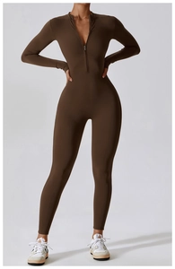 Close-up of the dark brown high-stretch fabric and front zipper on the yoga bodysuit