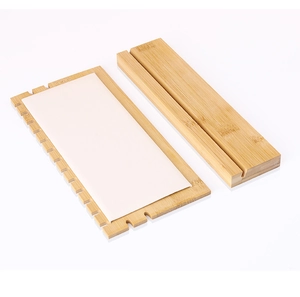 Close-up of bamboo wood necklace display rack base with serrated edges and slotted support