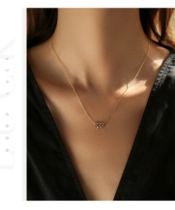Gros plan d'un collier en argent S925 doré avec pendentif chiffre 888 porte-bonheur