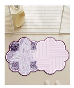 Detail of flower-shaped absorbent bathroom mat in purple and pink with modern textures