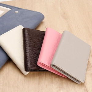 Close-up of colorful genuine leather business card holders with textured lychee grain