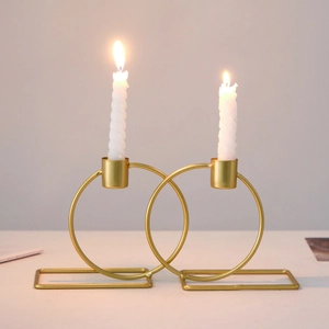 Nordic double-ring metal candle holder in gold finish with white spiral candles