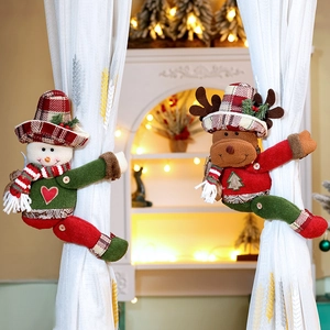 Detail of plush snowman and reindeer Christmas curtain buckles with plaid hat accents