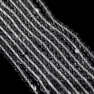 Macro shot of high-transparency glass beads on a black background for jewelry DIY