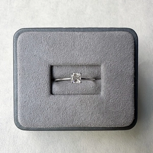 Top view of Asscher cut moissanite ring set in S925 sterling silver in a gray jewelry box
