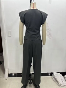 Back view of a black two-piece set featuring a cap-sleeve top and wide-leg trousers