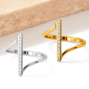 Macro detail of wave band rings with micro-set zircons in gold and silver finishes