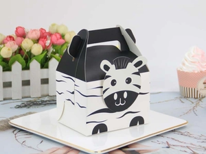 Detail of zebra pattern pastry gift box with handle and folding design on tray