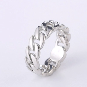 Detailed close-up of a silver-toned Cuban link chain ring with a polished metallic finish