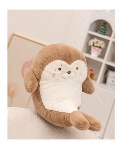Detailed close-up of soft seal plush toy with embroidered facial features on white surface