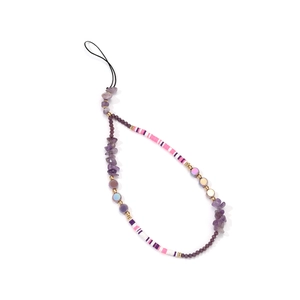 Detail of handmade beaded phone strap with purple stones, pink beads, and golden spacers