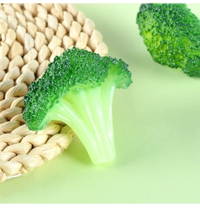 Macro detail of artificial broccoli model with realistic texture on woven mat background