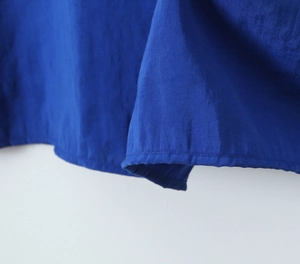Close-up of high-density navy fabric showing precise hem stitching and twill texture