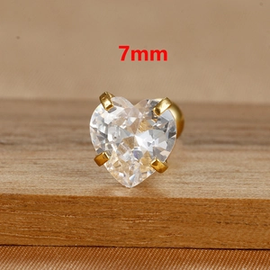 Macro shot of 7mm heart-shaped cubic zirconia stud earrings with gold claw settings