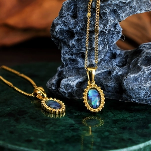 Bohemian gold stainless steel necklace featuring oval abalone shell pendant on green marble