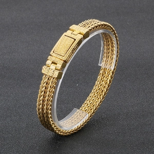 Macro detail of gold plated stainless steel wheat link chain with vintage engraved buckle