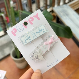 Sparkly acrylic hair clip set with cute puppy and pink ribbon bow on display card