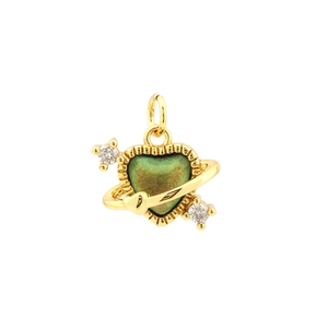 Macro detail of 18K gold plated heart planet pendant with green crystal and zircon accents