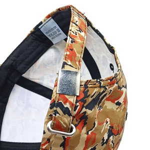 Detail of tiger camo baseball cap back with adjustable strap and silver metal buckle