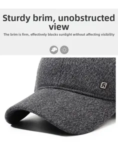 Detailed close-up of dark grey wool baseball cap with stiff brim and metal logo