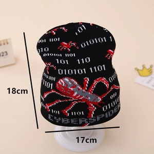 Detail view of black knit beanie featuring white binary code and red spider jacquard patterns