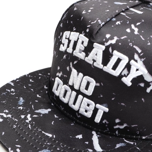 Detail of 3D embroidery STEADY NO DOUBT on a black and white splash ink flat brim cap