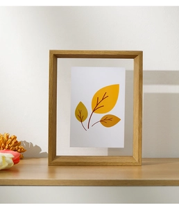 Macro shot of a minimalist solid wood photo frame with floating clear acrylic display