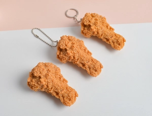 Detailed view of realistic PVC fried chicken drumstick keychains with different hooks