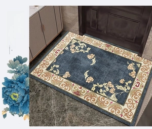 Detailed close-up of dark blue entryway rug with beige peony pattern on marble floor
