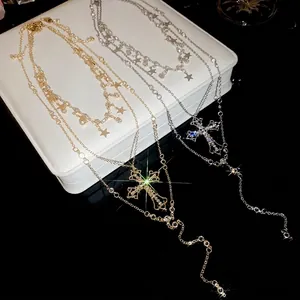 Layered gold and silver cross and star pendant necklaces with crystal accents