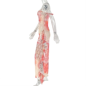 Detailed side view of ruffle hem on a slim-fit orange floral long sleeveless dress