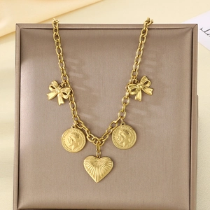 Close-up of golden stainless steel heart pendant and portrait coins on double-layer necklace