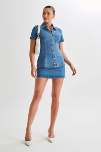 Détails d'un ensemble en jean bleu avec chemise à manches courtes et mini-jupe