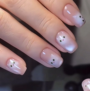 Close-up of pink gradient cat-themed press-on nails with cute cartoon animal designs