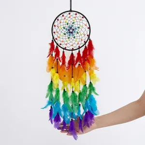 Detailed close-up of rainbow feathers and hand-woven beads on a boho dreamcatcher