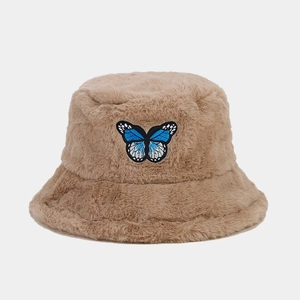 Detail of blue butterfly embroidery on thick plush camel winter bucket hat texture