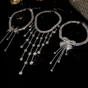 Elegant rhinestone tassel necklaces with butterfly motifs on high-gloss black background