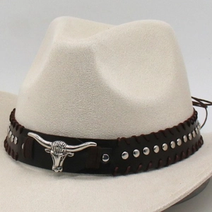 Close-up of beige cowboy hat with brown leather band and silver bull head metal ornament