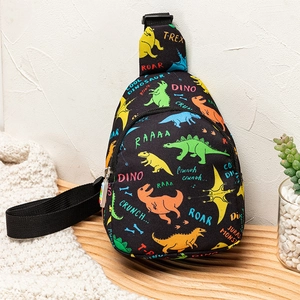 Close-up of kids dinosaur chest bag with colorful T-Rex patterns on a wooden surface