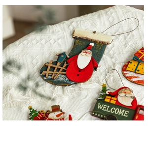 Detail of hand-painted wooden Christmas ornaments on white knit blanket background
