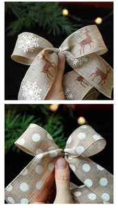 Close-up of burlap Christmas ribbon featuring reindeer, snowflake prints and textured bow