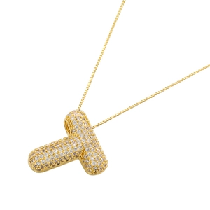 Detail of 18K gold plated balloon letter T pendant encrusted with sparkling white zircons