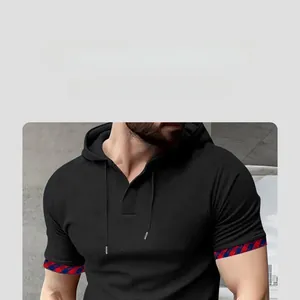 Detail shot of men's black waffle hoodie shirt with red and blue plaid cuff piping trim