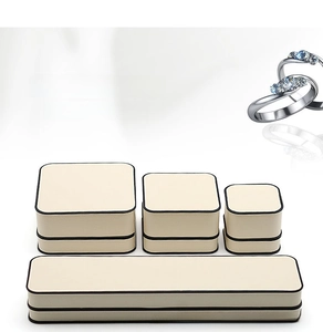 Detailed set of white faux leather jewelry boxes with black edges for rings and necklaces
