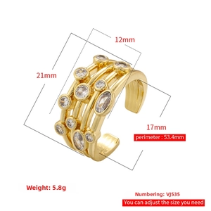 Macro shot of gold multi-layer adjustable open ring featuring clear zircon stone accents