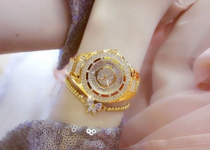 Detail of luxury gold women watch set with full diamonds and crystal butterfly bracelet
