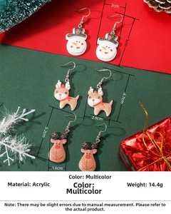 Macro detail of acrylic Christmas earrings set with glitter reindeer and snowman icons