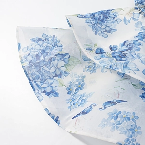 Floral one-shoulder dress featuring blue hydrangea and bird prints on white mesh fabric