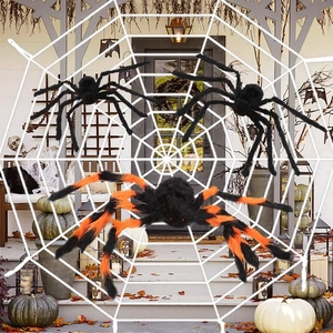 Detail of giant white spider web with black and orange spiders on a Halloween porch decoration